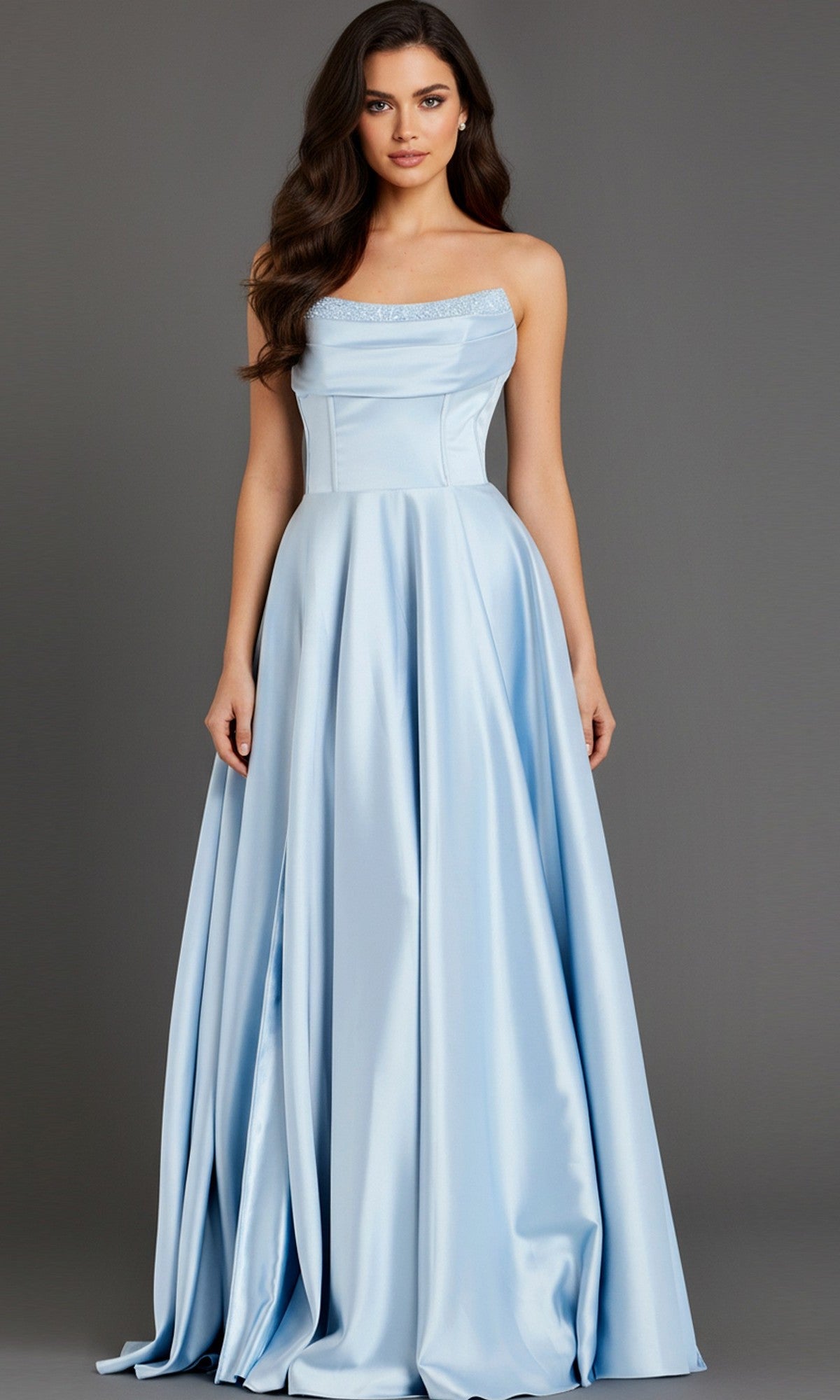 A woman wears the Jovani 46483 Long Prom Dress, a strapless satin A-line gown with beaded trim, standing against a plain gray background.